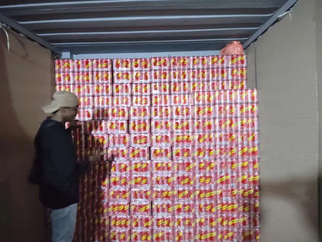 Rows of beverage cartons inside a container